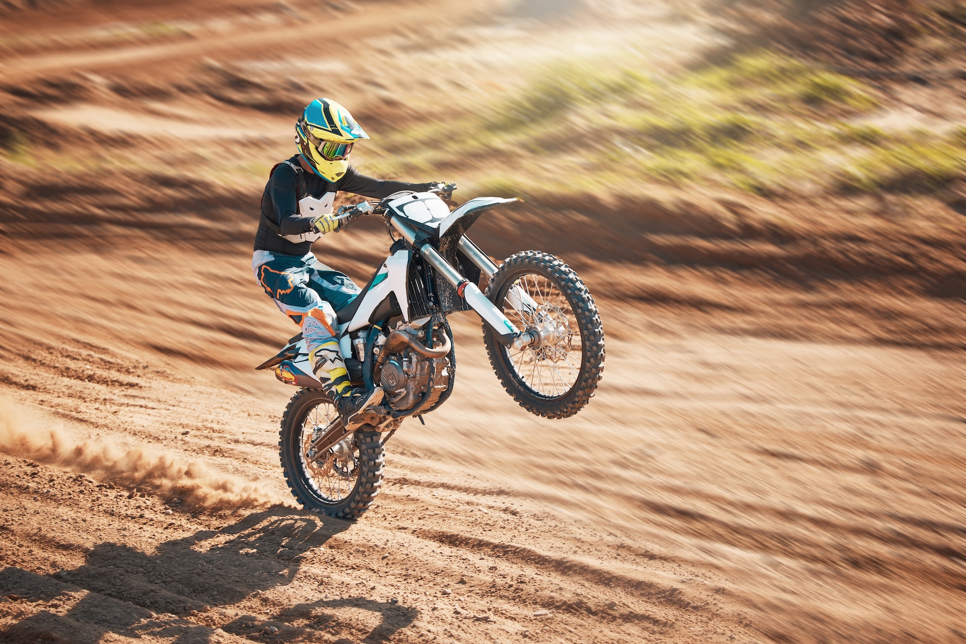 Motorcycle, dirt track stunt and air jump in desert, sand trail and freedom. Driver, cycling and of